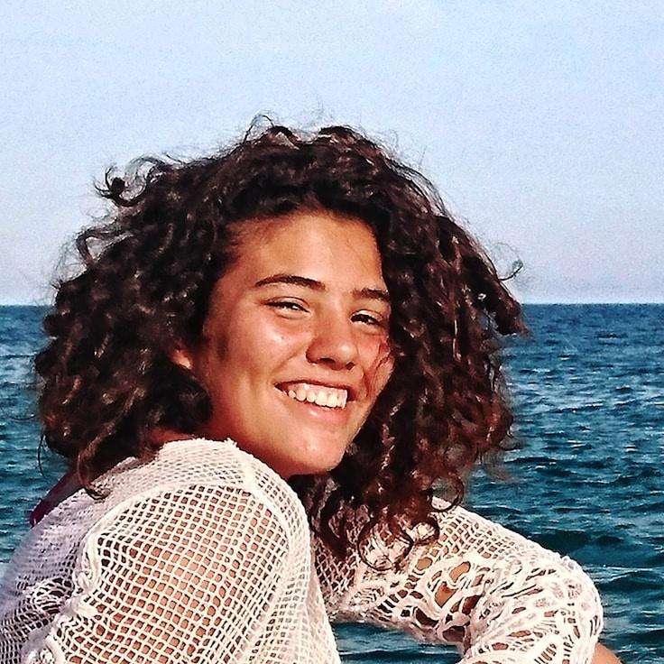 Ari Mehta, Lead Design Curator at Silent Market Node, reviewing corporate floral arrangements